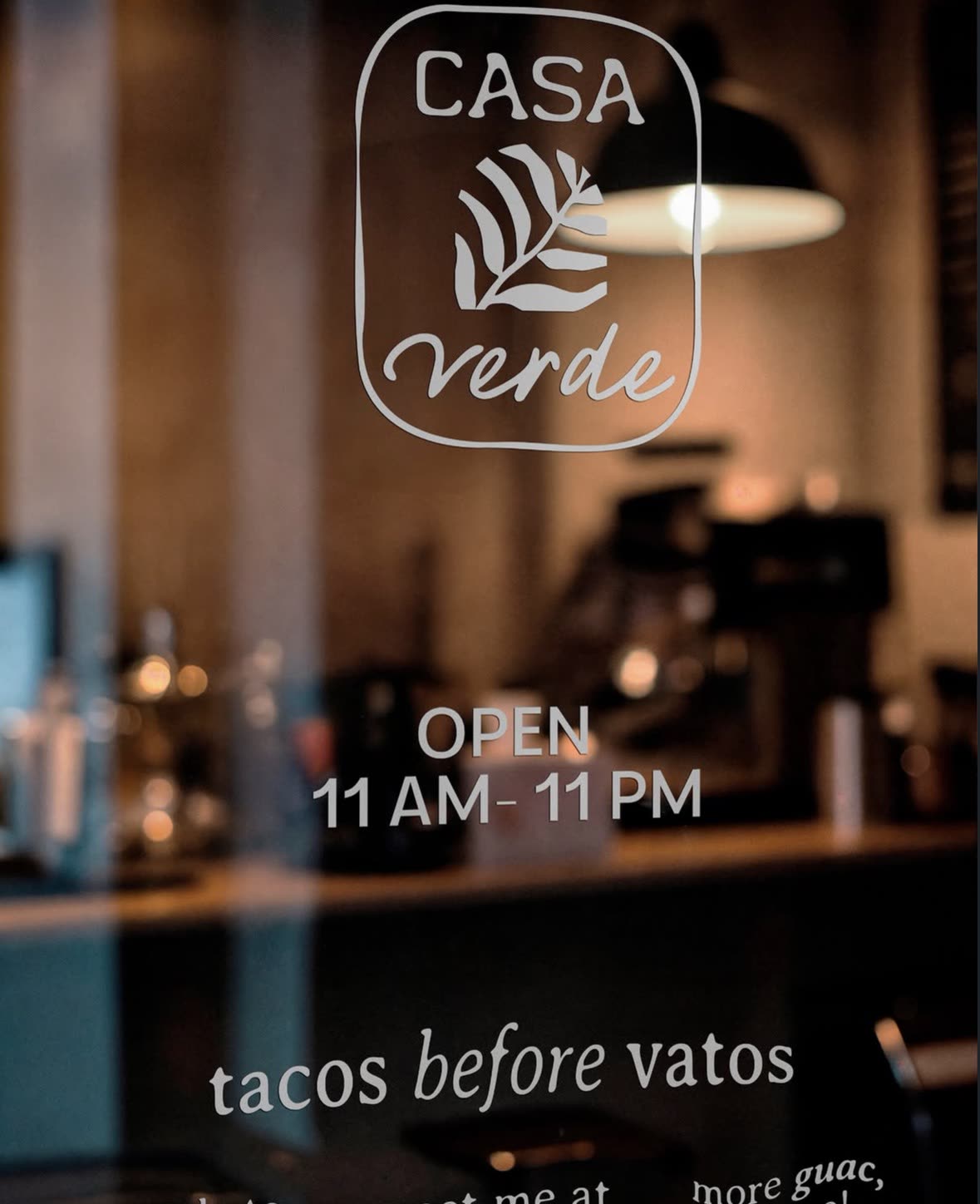 Casa Verde door decal: open 11am to 11pm, tacos before vatos